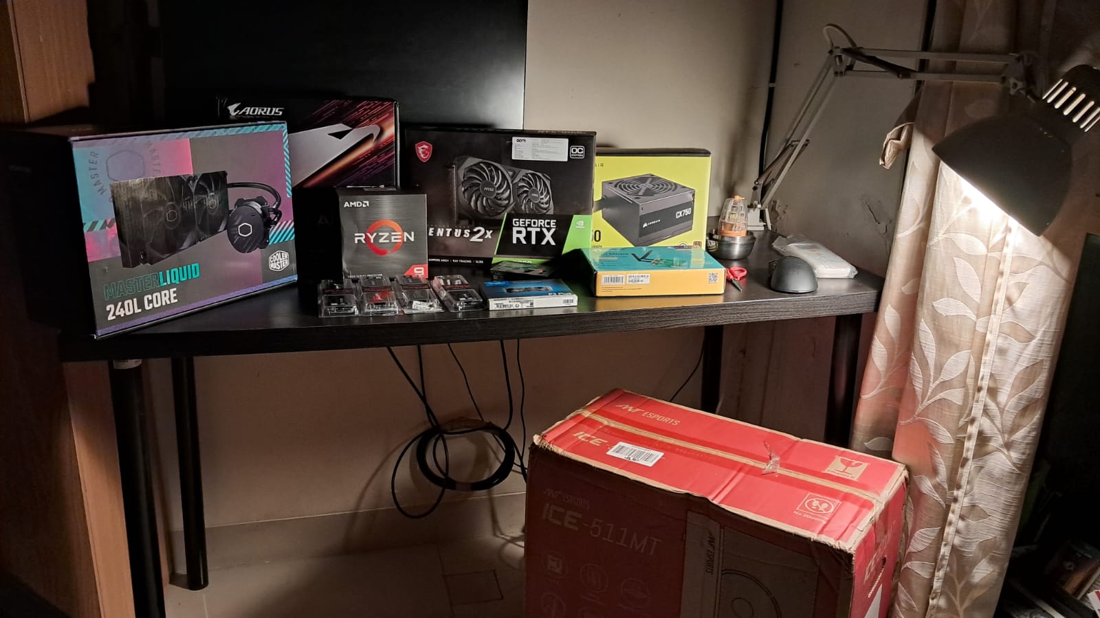 Computer components on a table with desk light